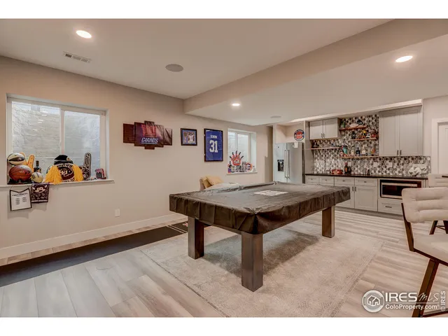a bedroom with a bed a dresser and book self
