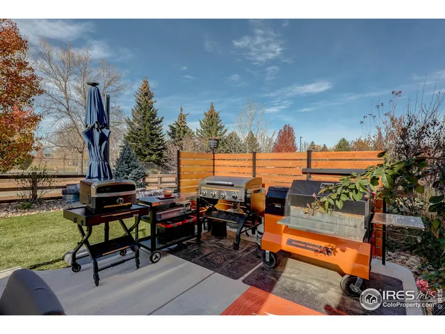 a dining room with furniture and large windows