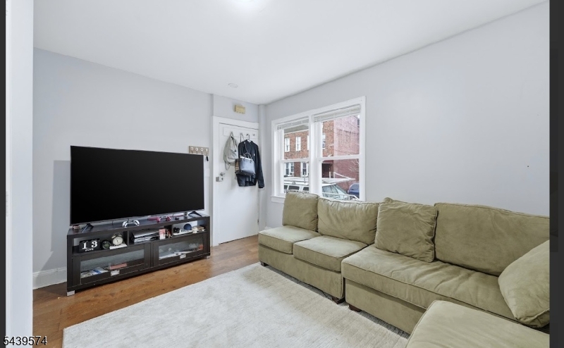 328 John Street Elizabeth, NJ 07202 - Photo 3 of 9 a living room with furniture and a flat screen tv