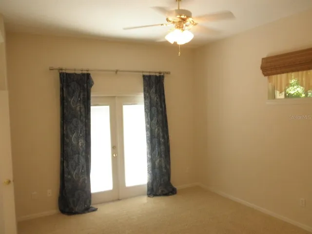 an empty room with windows and closet