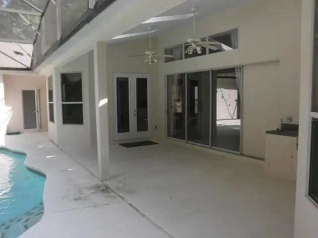 a view of a porch with furniture and floor to ceiling window
