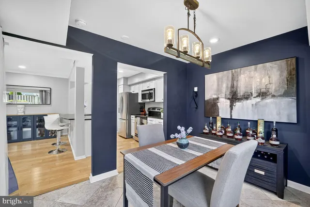 a view of a dining room with furniture a chandelier and wooden floor