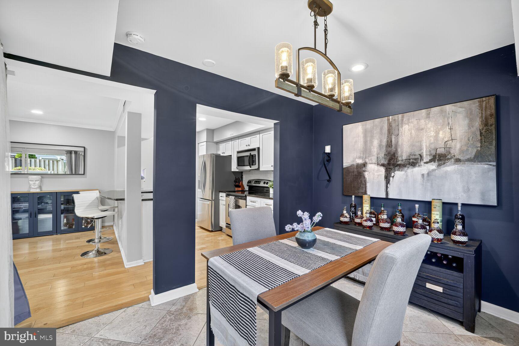 4519 28th Road South, Unit A Arlington, VA 22206 - Photo 4 of 33 a view of a dining room with furniture a chandelier and wooden floor