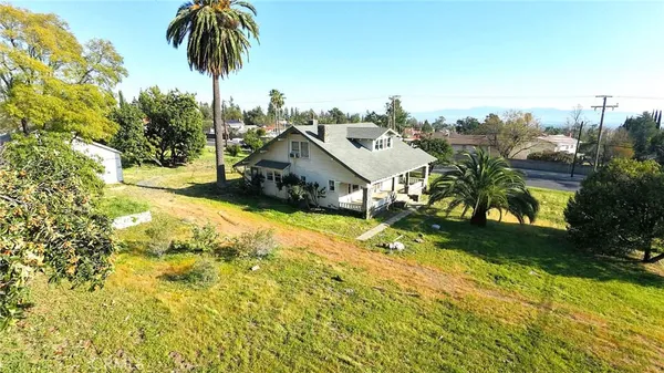 an aerial view of a house with swimming pool and garden