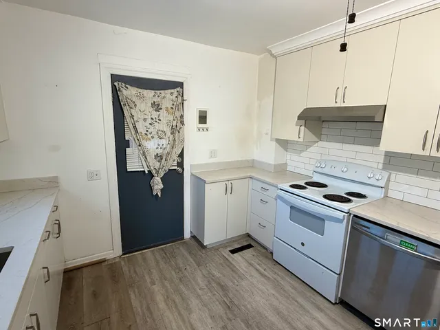 a kitchen with stainless steel appliances granite countertop a stove and a refrigerator