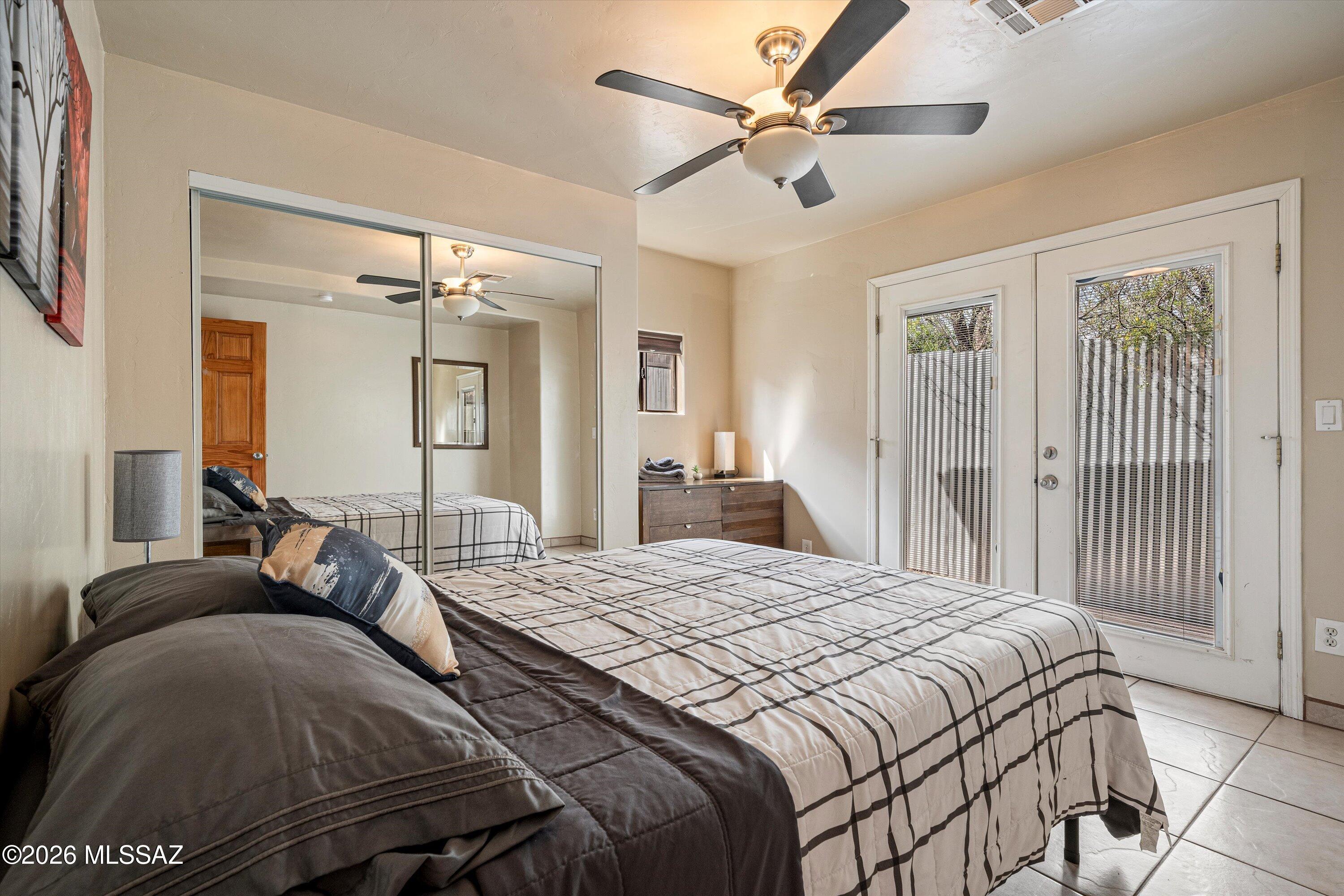 2619 East Prince Road Tucson, AZ 85716 - Photo 38 of 50 a bedroom with a large bed and a chandelier