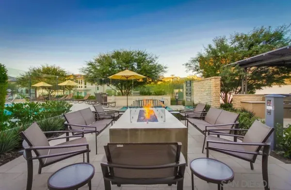 a large living room with stainless steel appliances granite countertop a couch and a large window