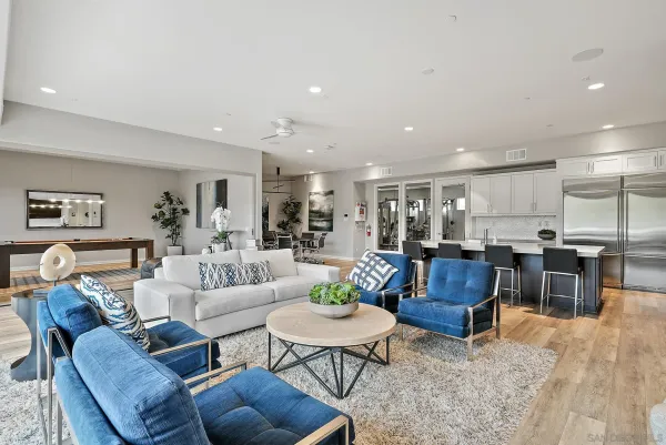 a large kitchen with kitchen island a sink table and chairs