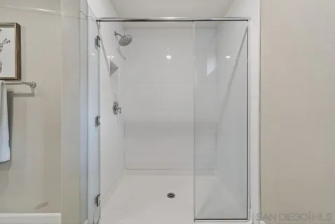 a bathroom with a glass shower door