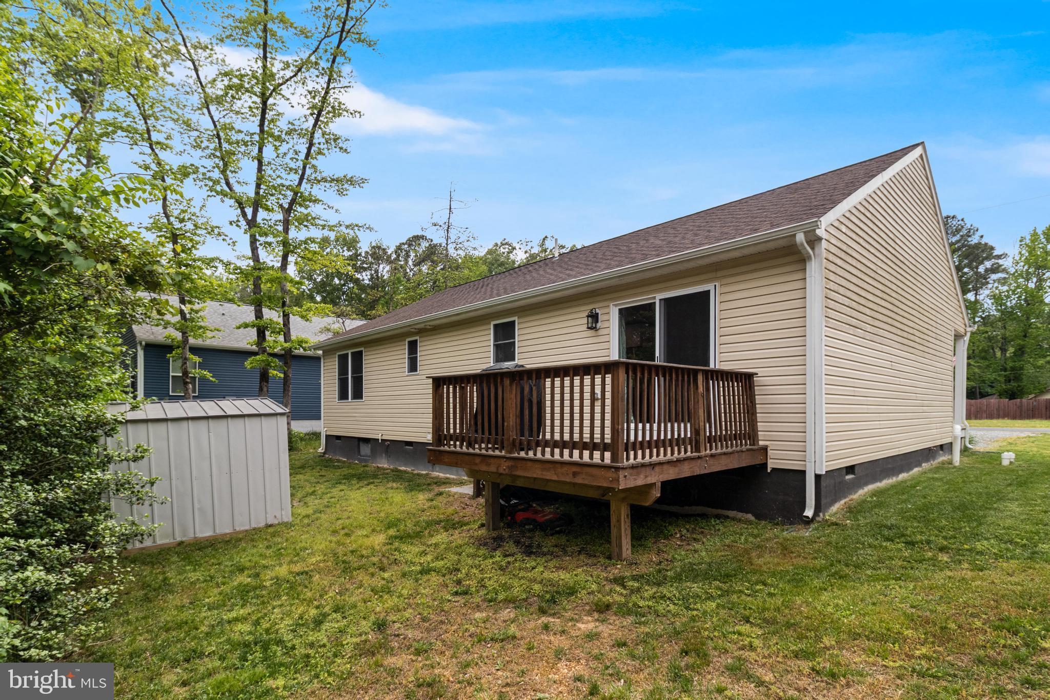 32 Placid Road Colonial Beach, VA 22443 - Photo 11 of 54 a view of a house with a yard and deck