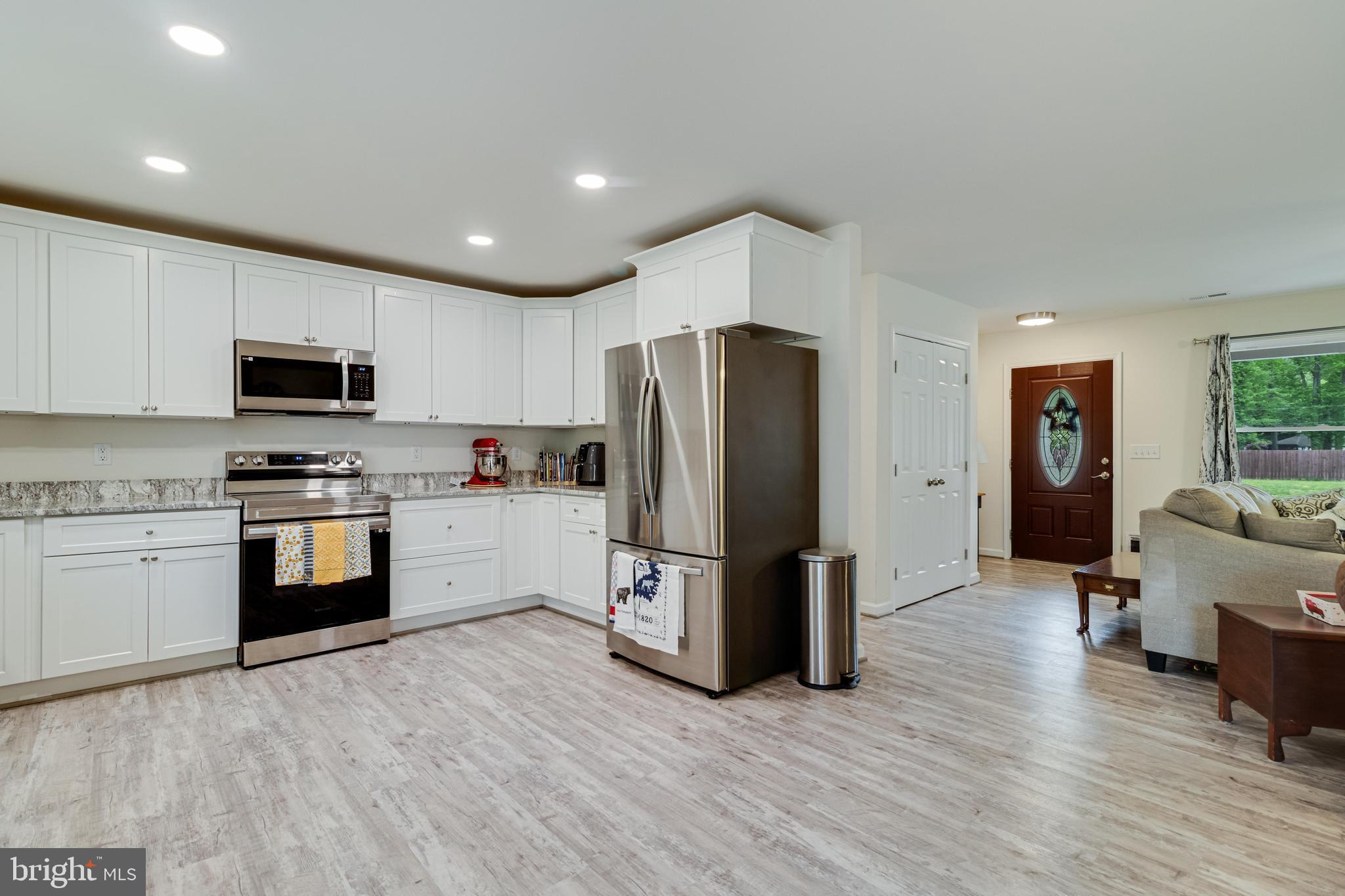 32 Placid Road Colonial Beach, VA 22443 - Photo 13 of 54 a kitchen with granite countertop a refrigerator stove and microwave