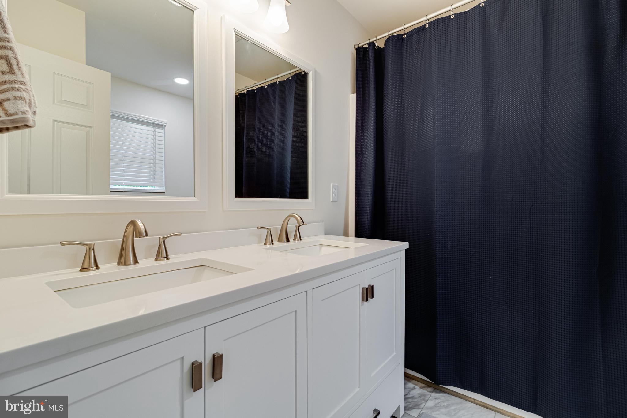 32 Placid Road Colonial Beach, VA 22443 - Photo 24 of 54 a bathroom with a sink and a mirror