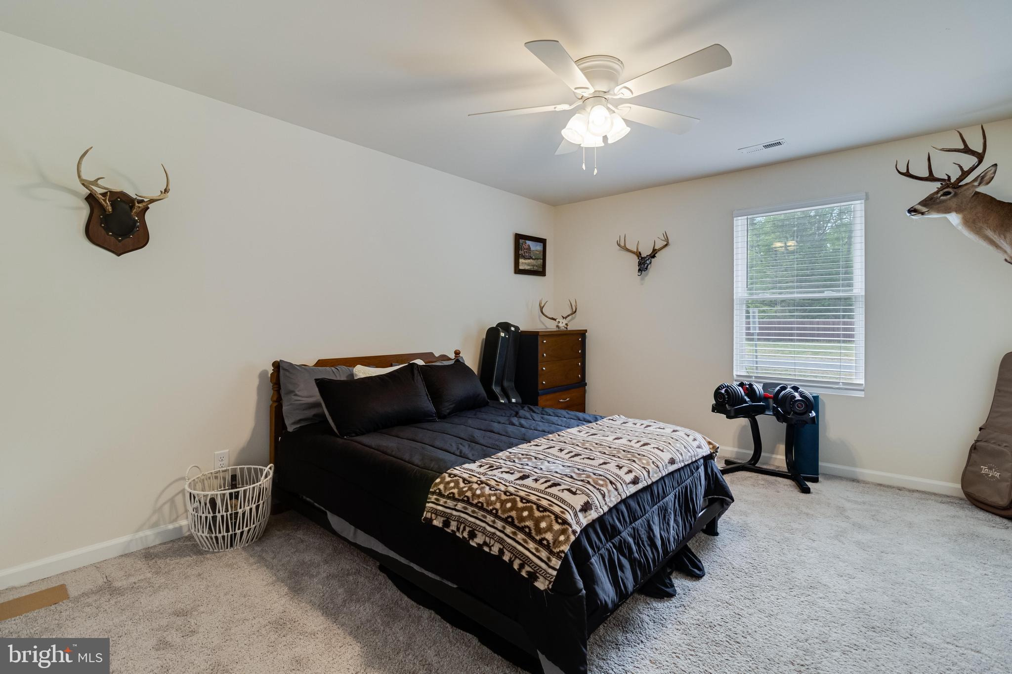 32 Placid Road Colonial Beach, VA 22443 - Photo 26 of 54 a bedroom with a bed and a chandelier