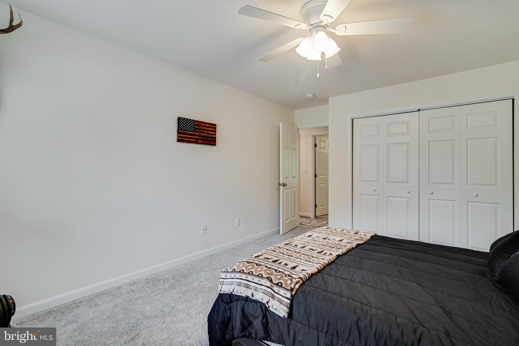 32 Placid Road Colonial Beach, VA 22443 - Photo 27 of 54 a bedroom with a bed and a chandelier
