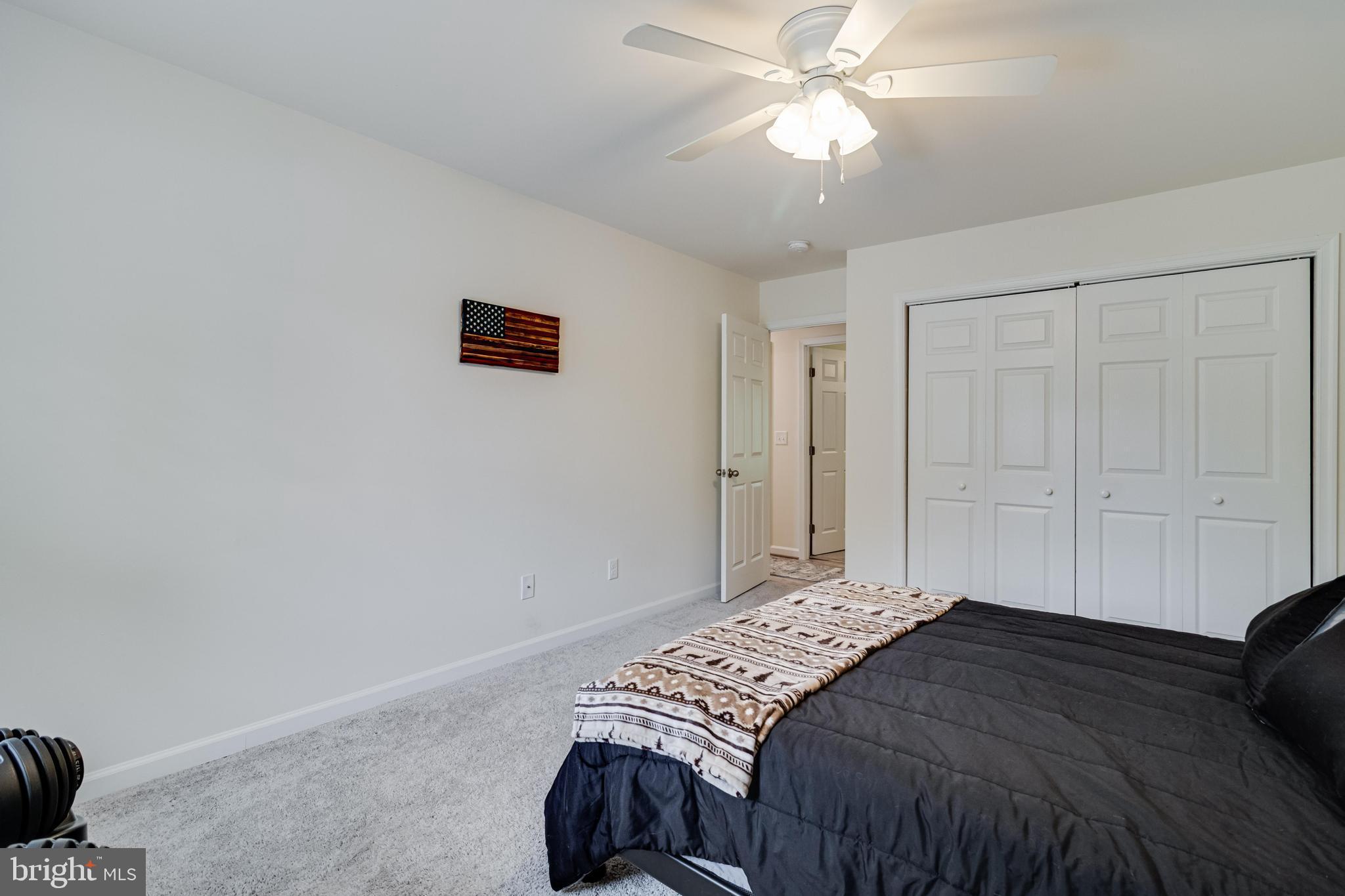 32 Placid Road Colonial Beach, VA 22443 - Photo 29 of 54 a bedroom with a bed and a chandelier