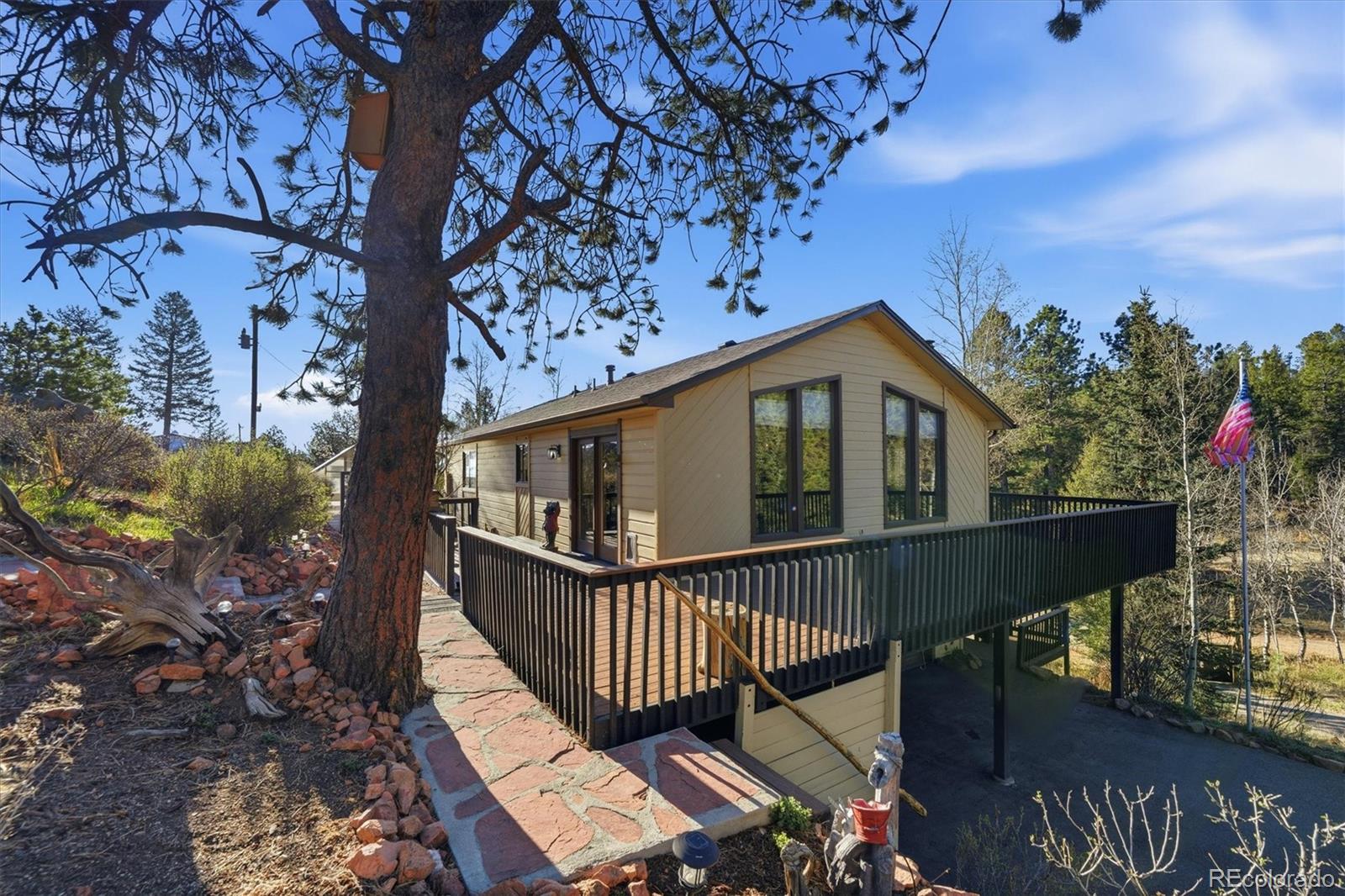 33799 Warren Road Pine, CO 80470 - Photo 16 of 50 a view of a house with wooden deck front of house