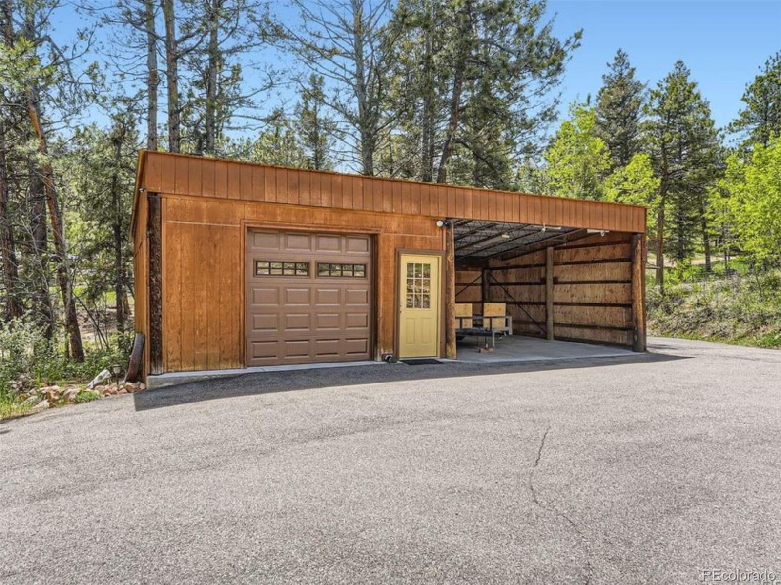 33799 Warren Road Pine, CO 80470 - Photo 19 of 50 front view of a house with a garage