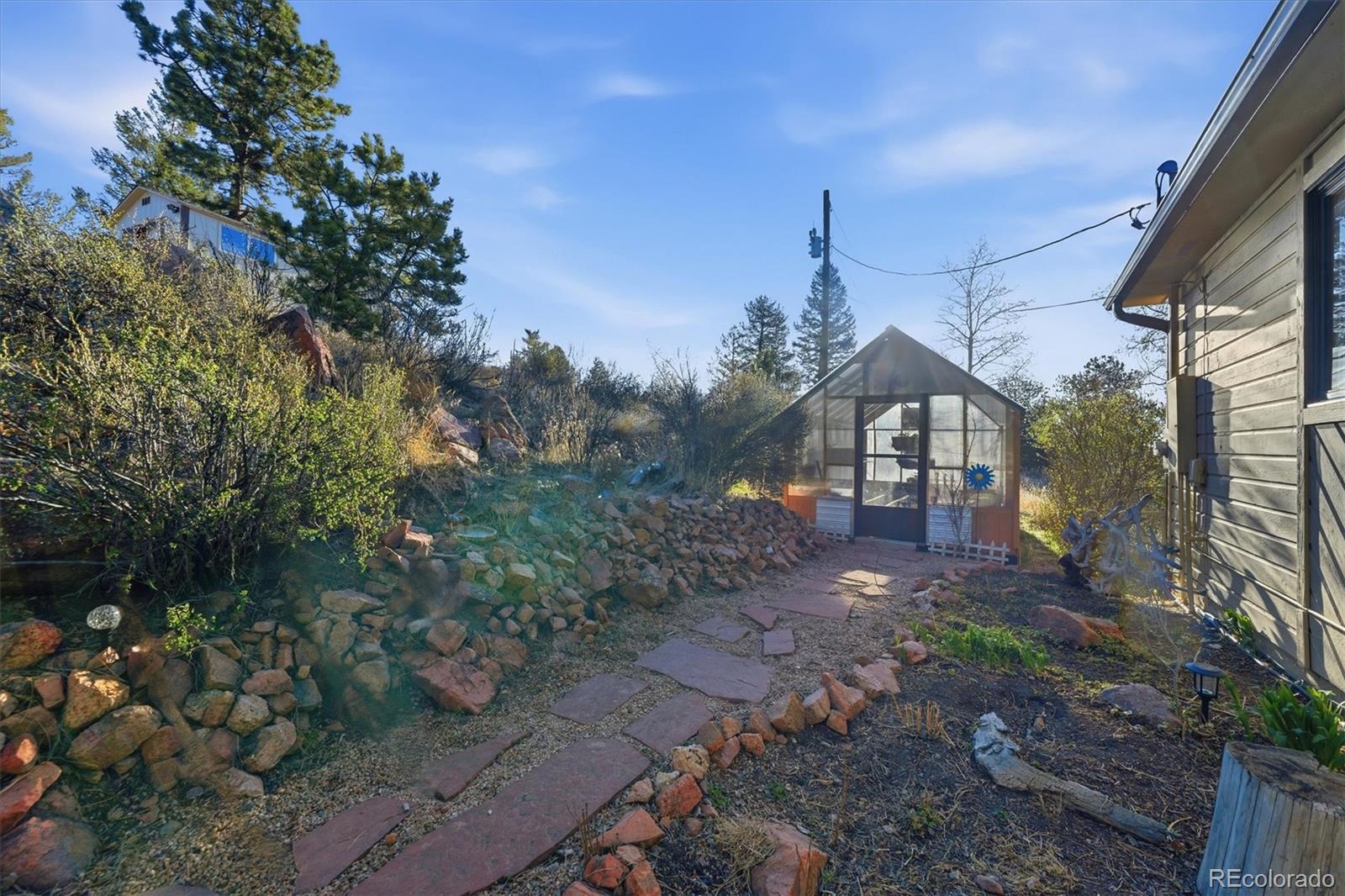33799 Warren Road Pine, CO 80470 - Photo 22 of 50 a view of a house with a yard