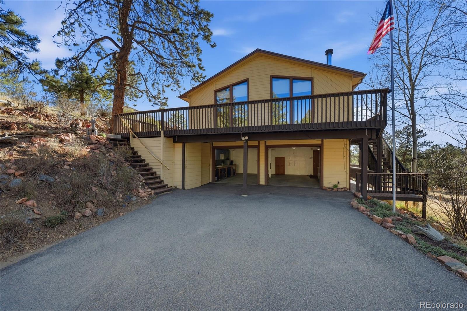 33799 Warren Road Pine, CO 80470 - Photo 25 of 50 a view of a house with a small yard and large tree