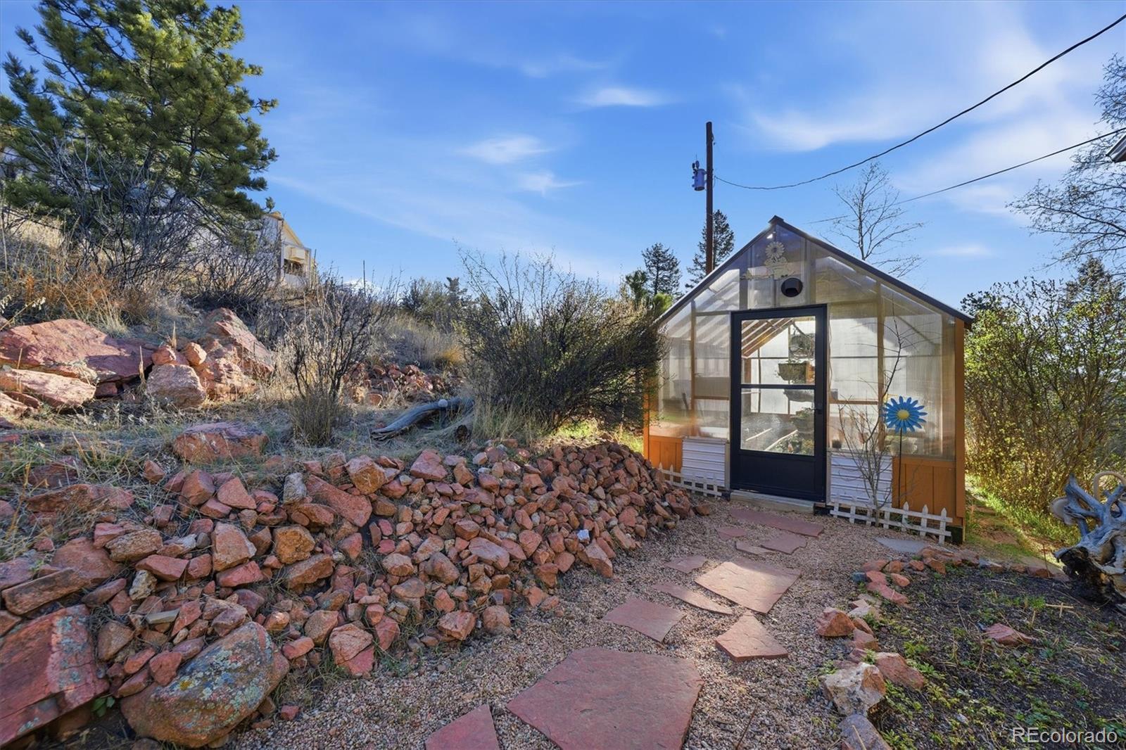 33799 Warren Road Pine, CO 80470 - Photo 27 of 50 a front view of a house with a yard