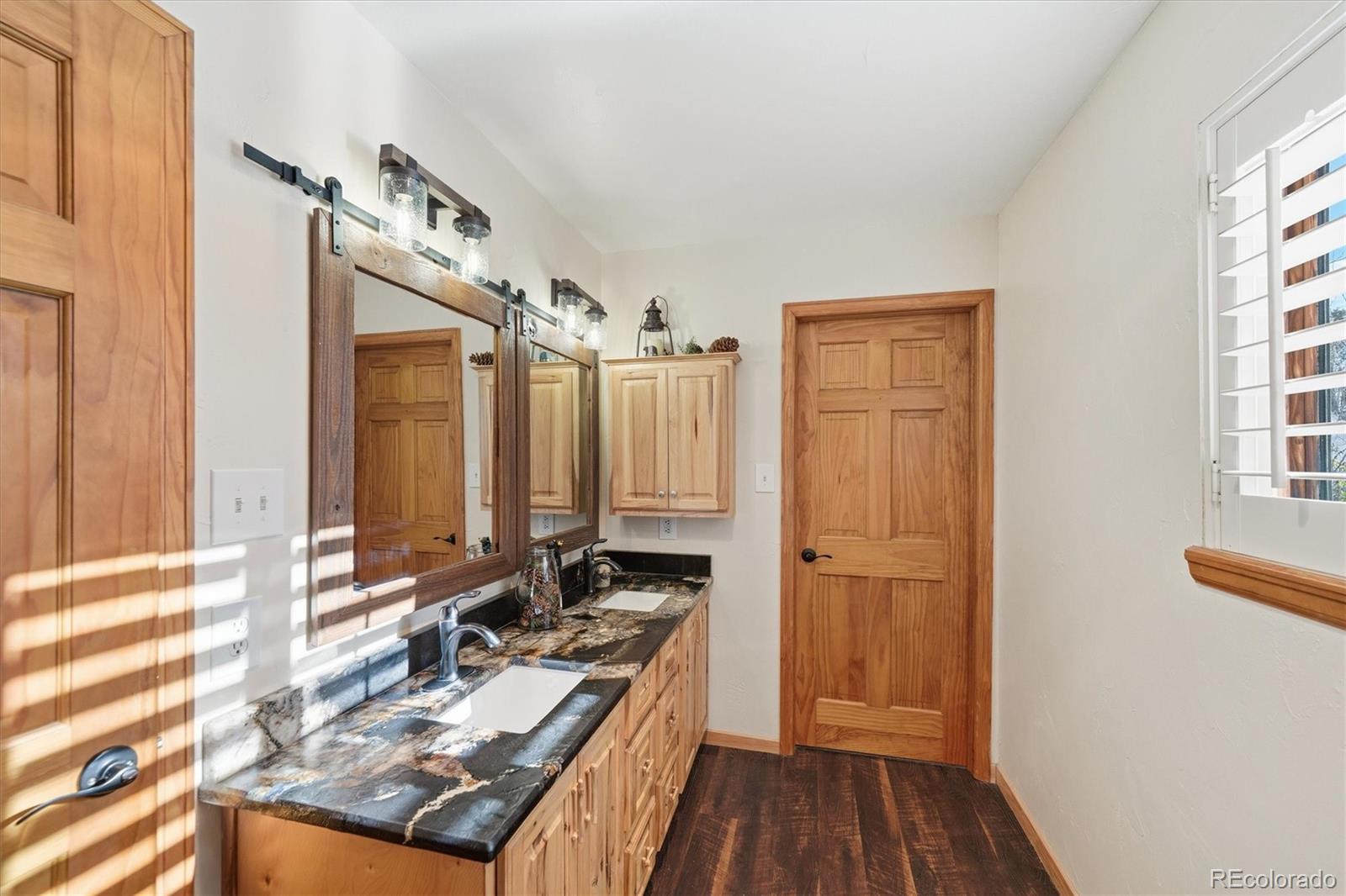 33799 Warren Road Pine, CO 80470 - Photo 38 of 50 a view of a house with a sink and wooden floor