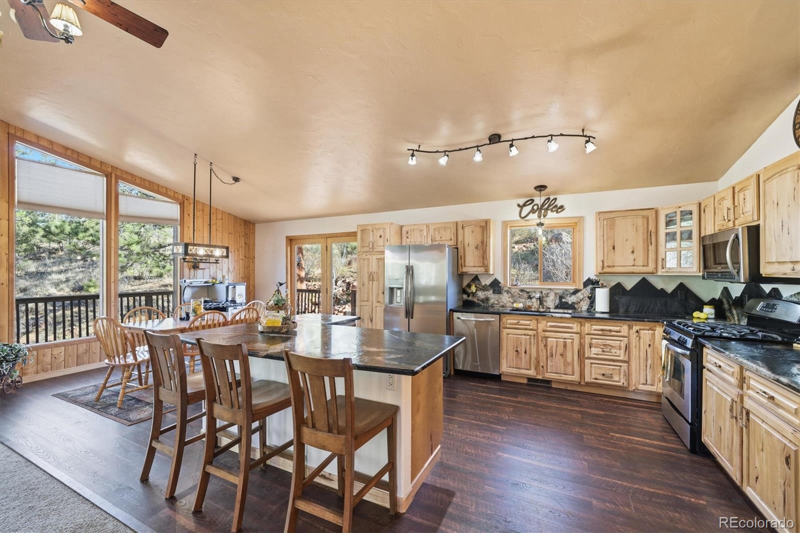 33799 Warren Road Pine, CO 80470 - Photo 4 of 50 a kitchen with lots of counter top space and wooden floor