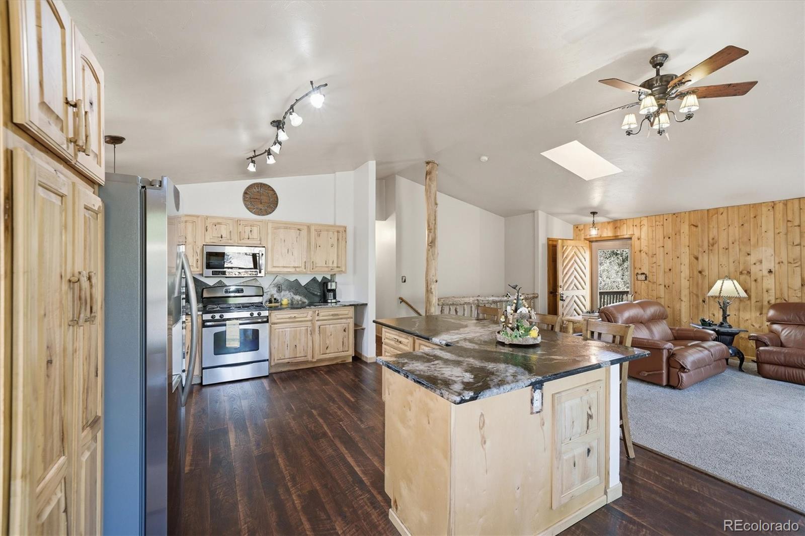 33799 Warren Road Pine, CO 80470 - Photo 41 of 50 a kitchen with stainless steel appliances granite countertop a stove and a refrigerator