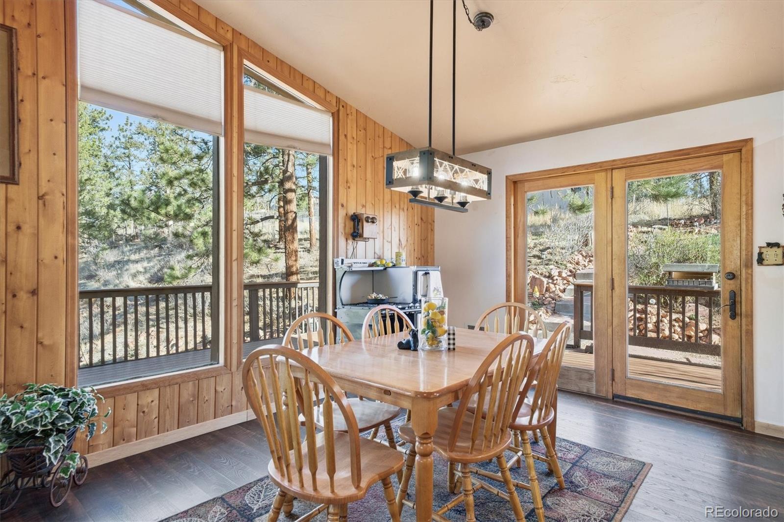 33799 Warren Road Pine, CO 80470 - Photo 42 of 50 a view of a dining room with furniture window and wooden floor