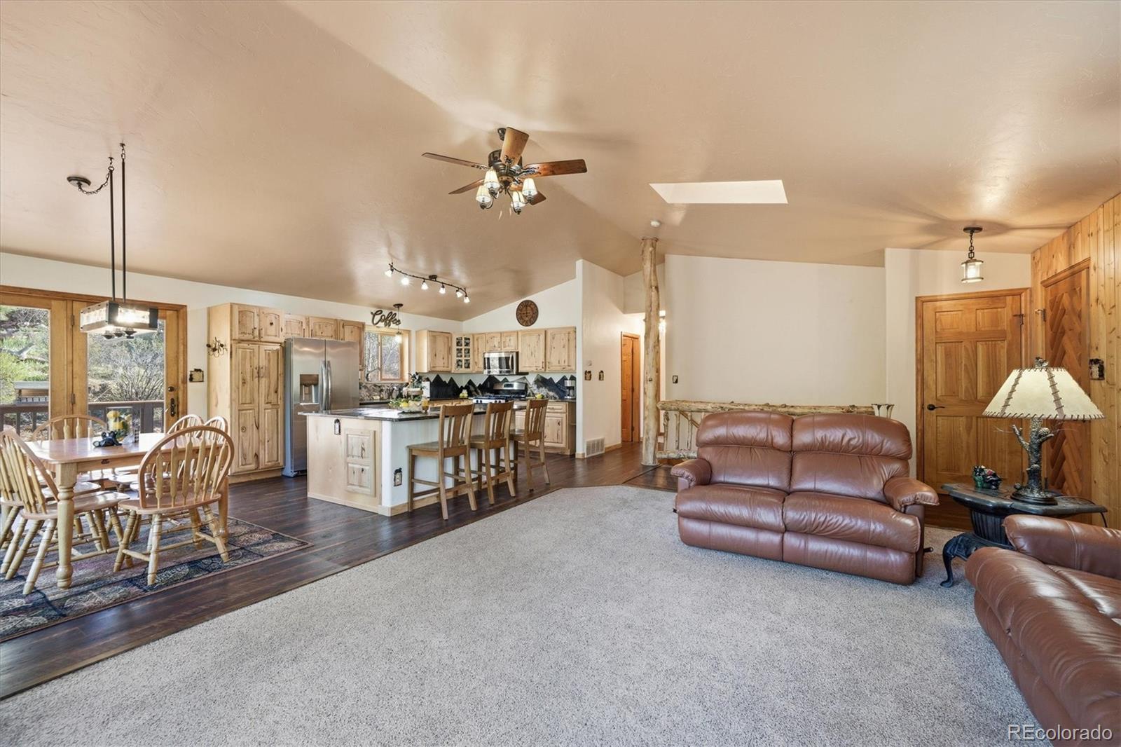 33799 Warren Road Pine, CO 80470 - Photo 43 of 50 a living room with furniture a ceiling fan and a chandelier