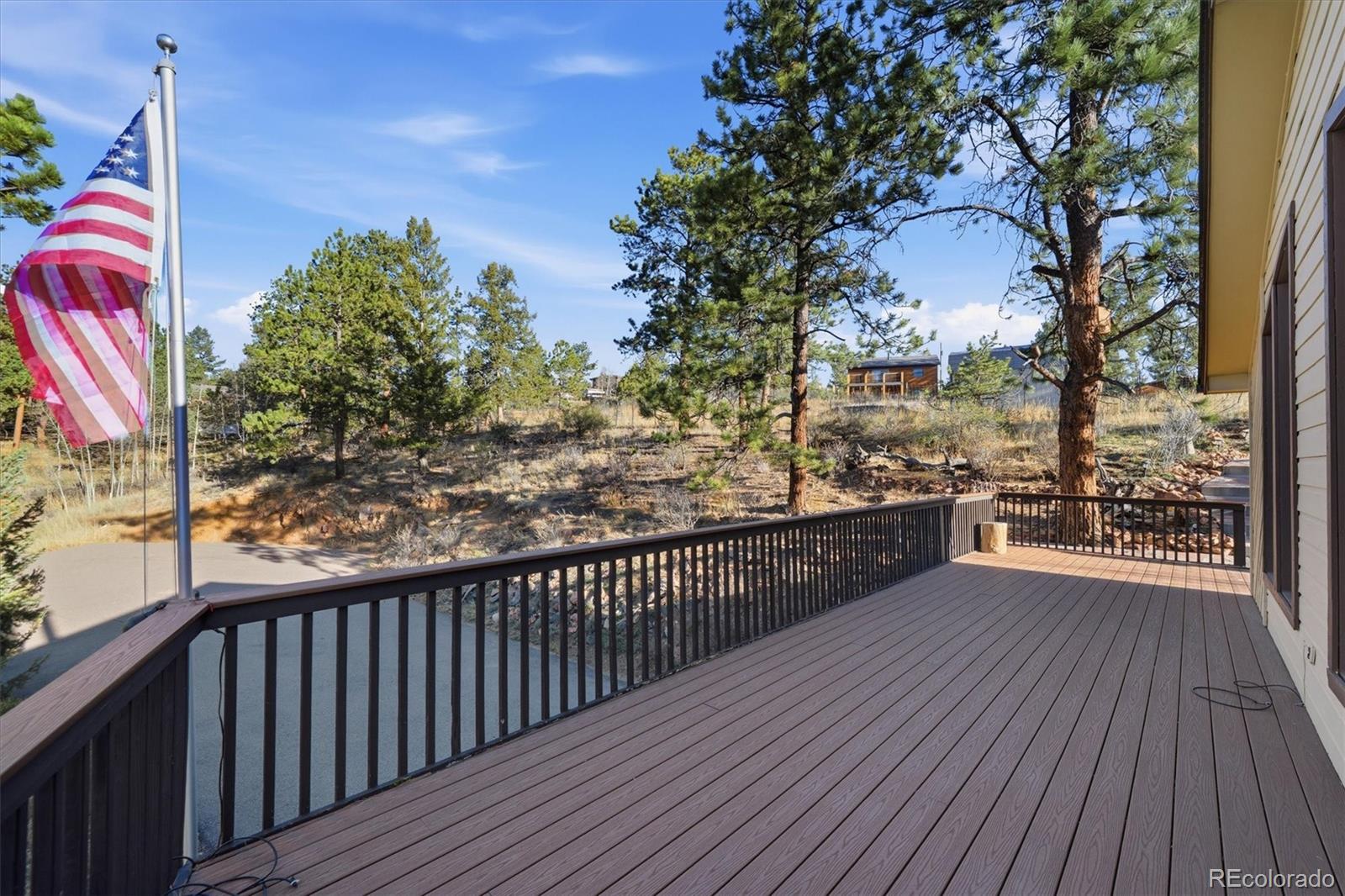 33799 Warren Road Pine, CO 80470 - Photo 47 of 50 a view of a balcony with wooden floor