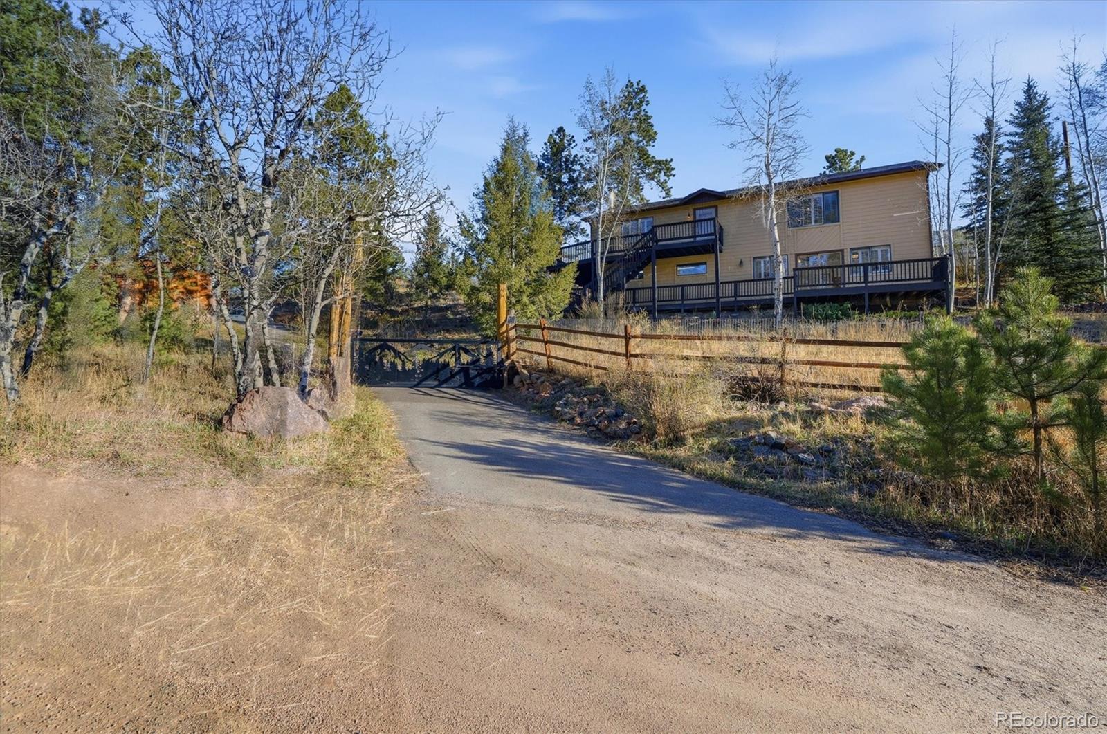 33799 Warren Road Pine, CO 80470 - Photo 48 of 50 a view of a house with a yard