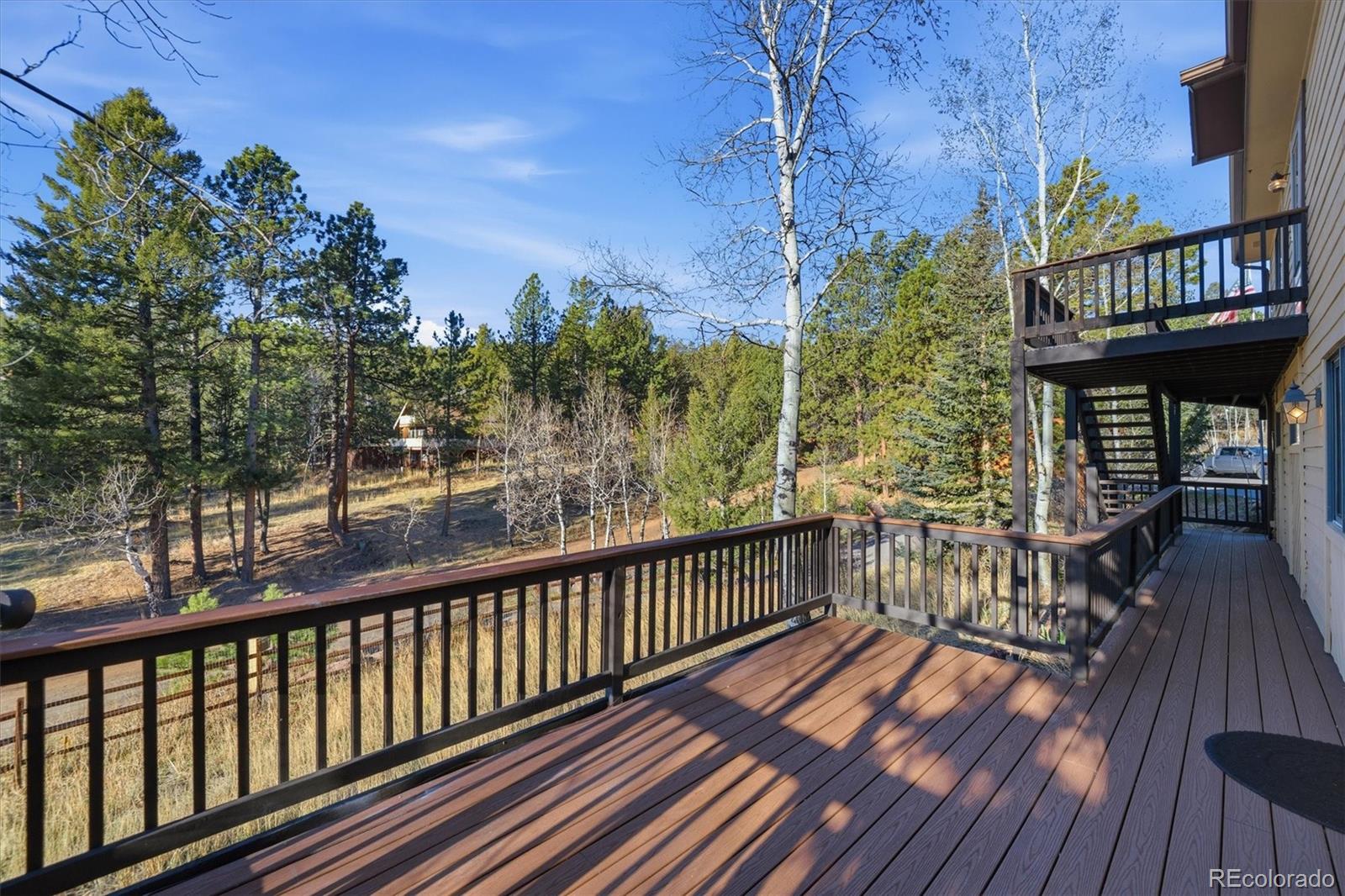 33799 Warren Road Pine, CO 80470 - Photo 7 of 50 a view of a balcony with wooden floor
