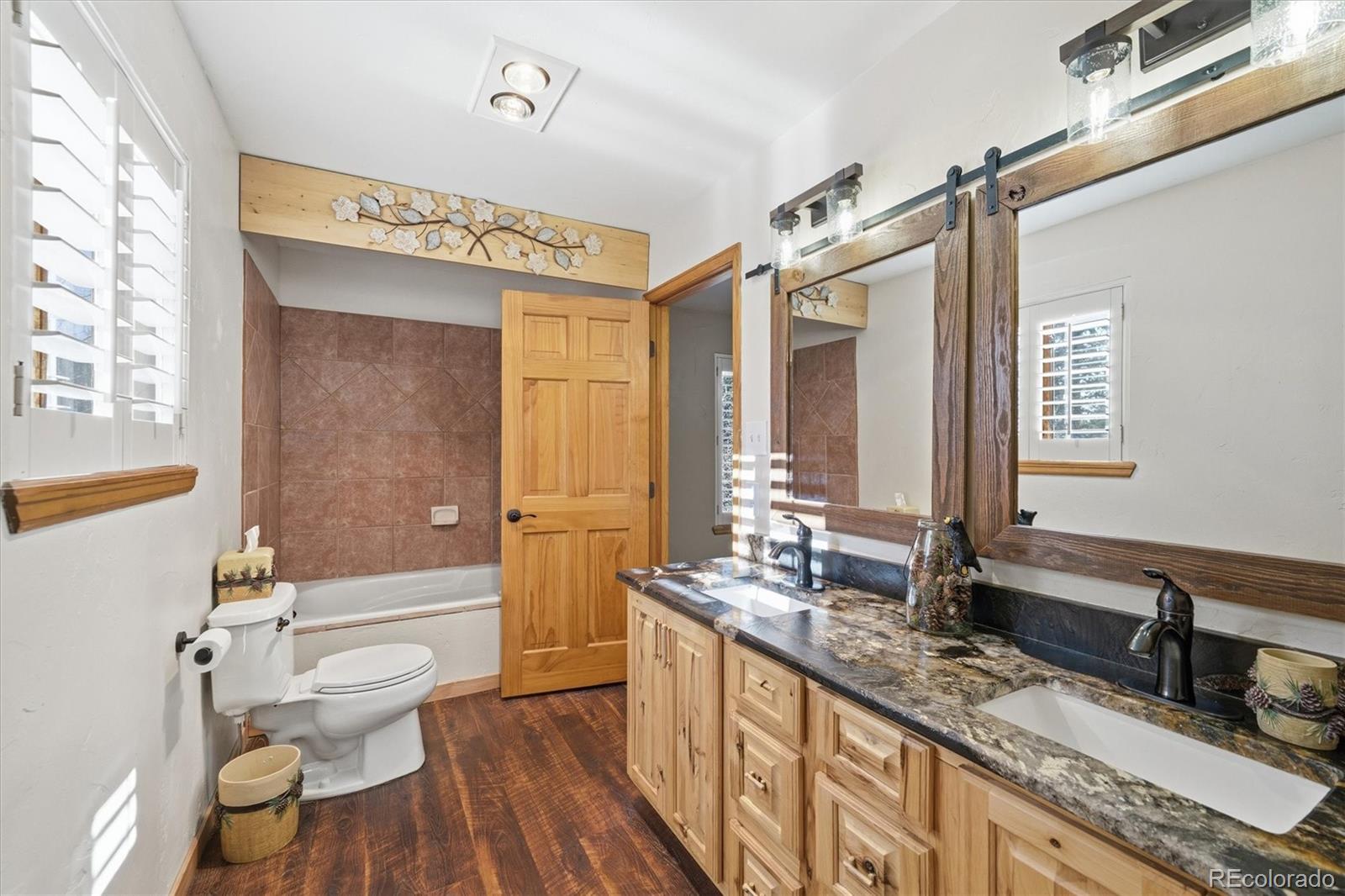 33799 Warren Road Pine, CO 80470 - Photo 9 of 50 a bathroom with a granite countertop sink mirror vanity and toilet