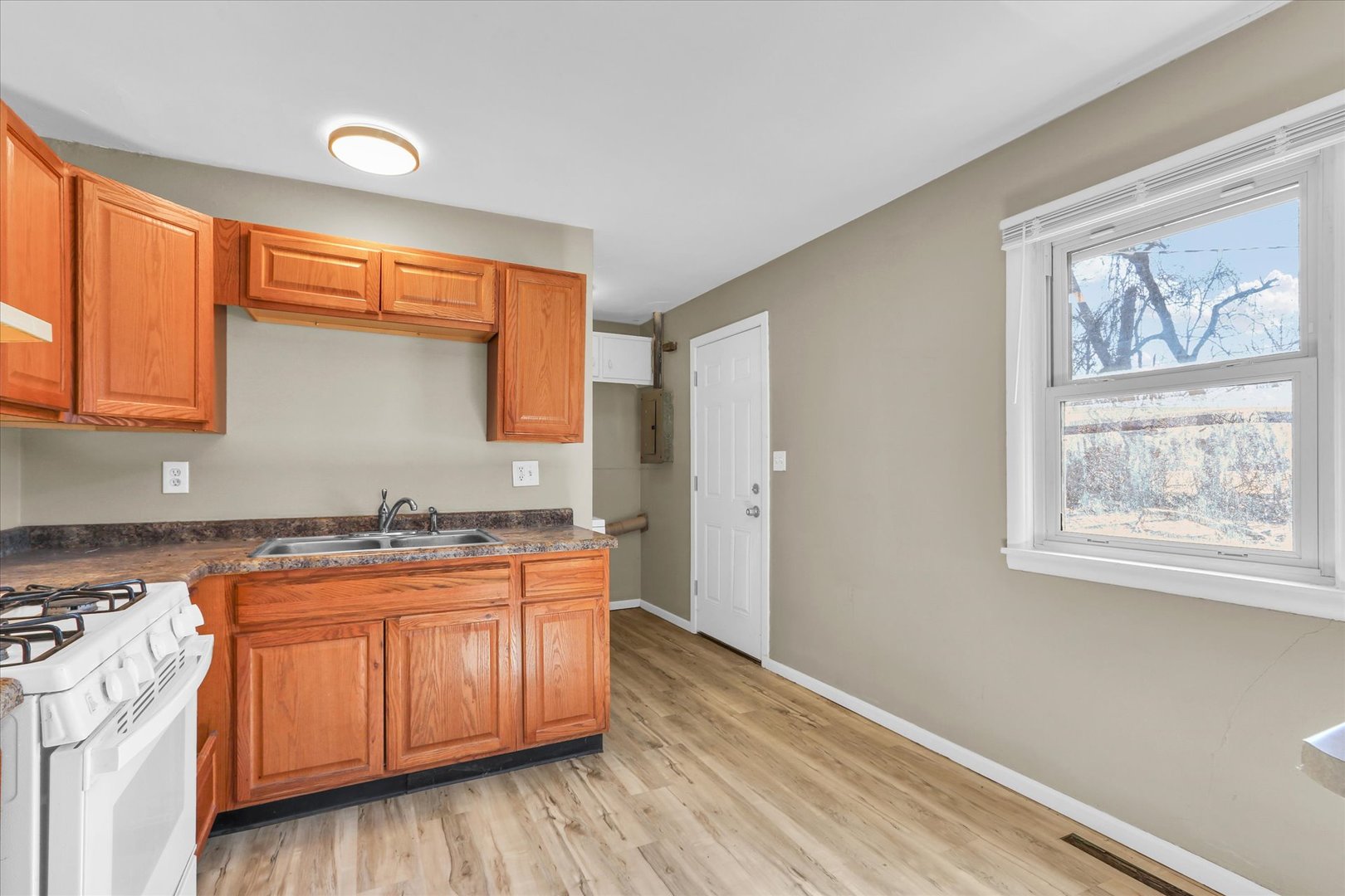 4 Hedge Court Champaign, IL 61821 - Photo 11 of 23 a kitchen with stainless steel appliances granite countertop a stove a sink and a wooden floors