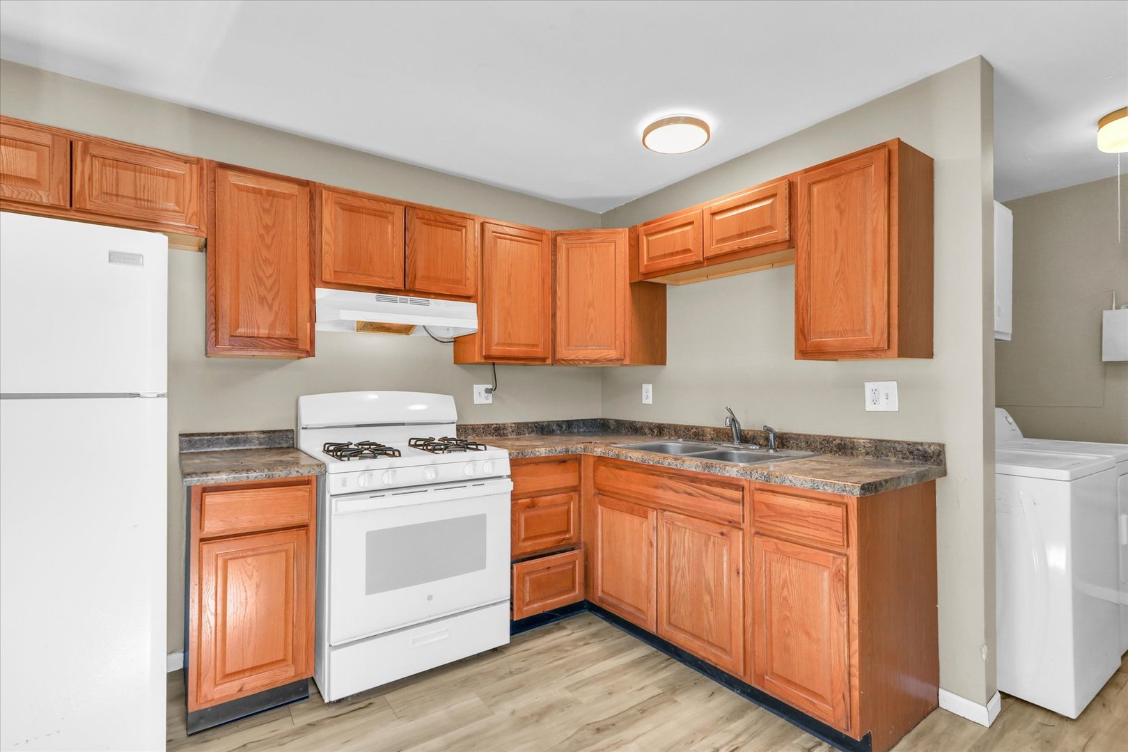 4 Hedge Court Champaign, IL 61821 - Photo 12 of 23 a kitchen with a stove a sink and a refrigerator