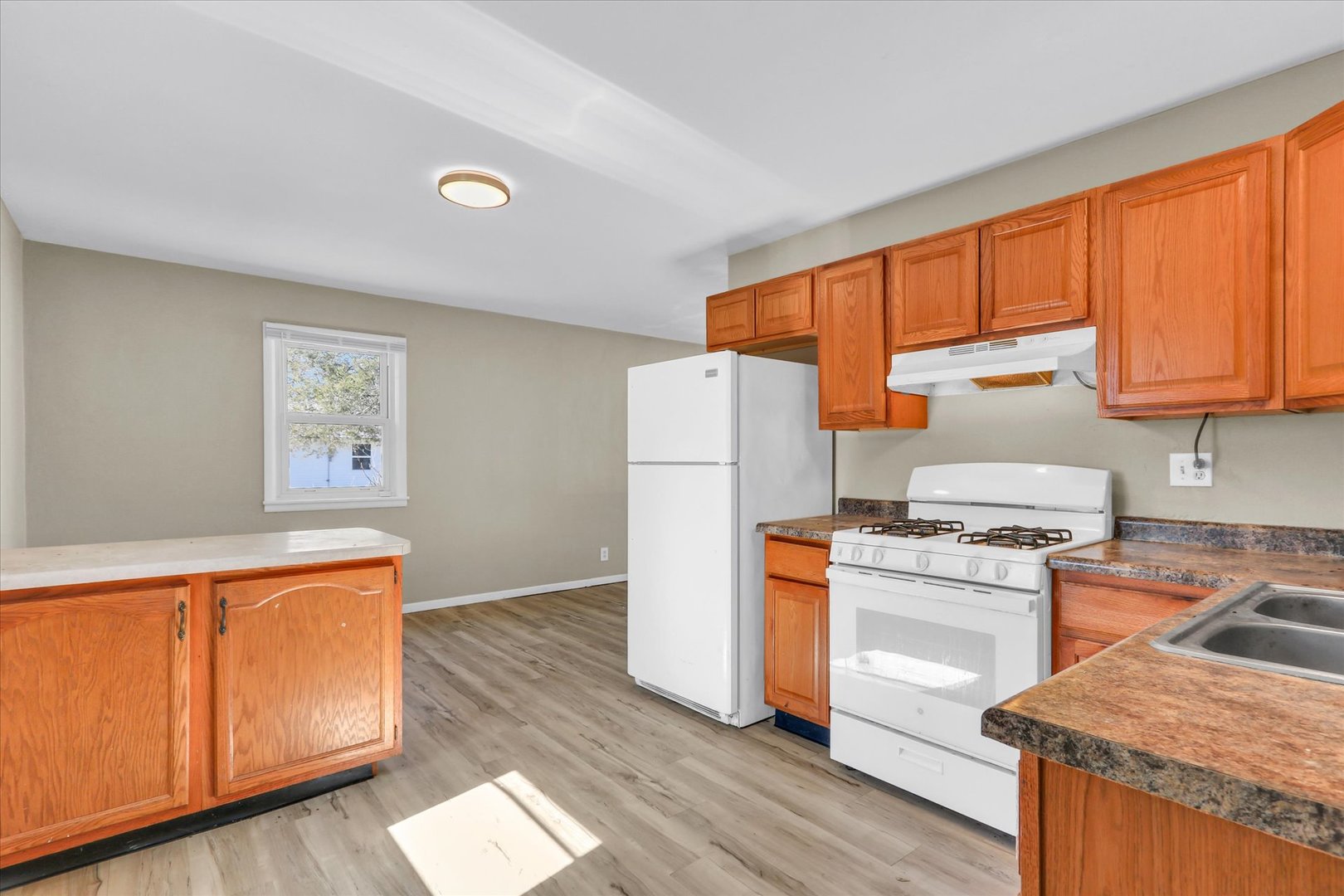 4 Hedge Court Champaign, IL 61821 - Photo 13 of 23 a kitchen with a refrigerator a stove top oven a counter space and wooden floor