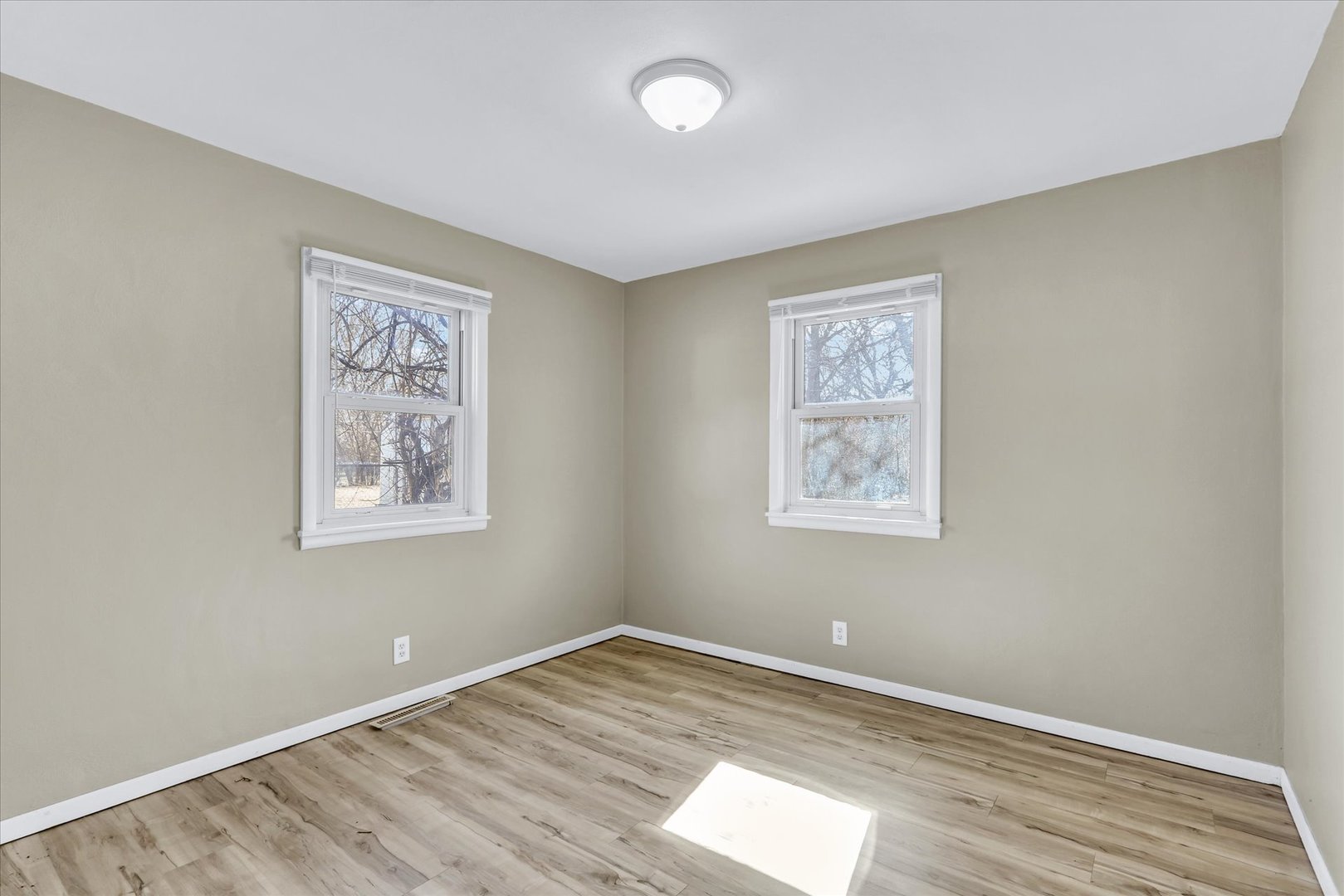 4 Hedge Court Champaign, IL 61821 - Photo 15 of 23 a view of an empty room with a window and wooden floor