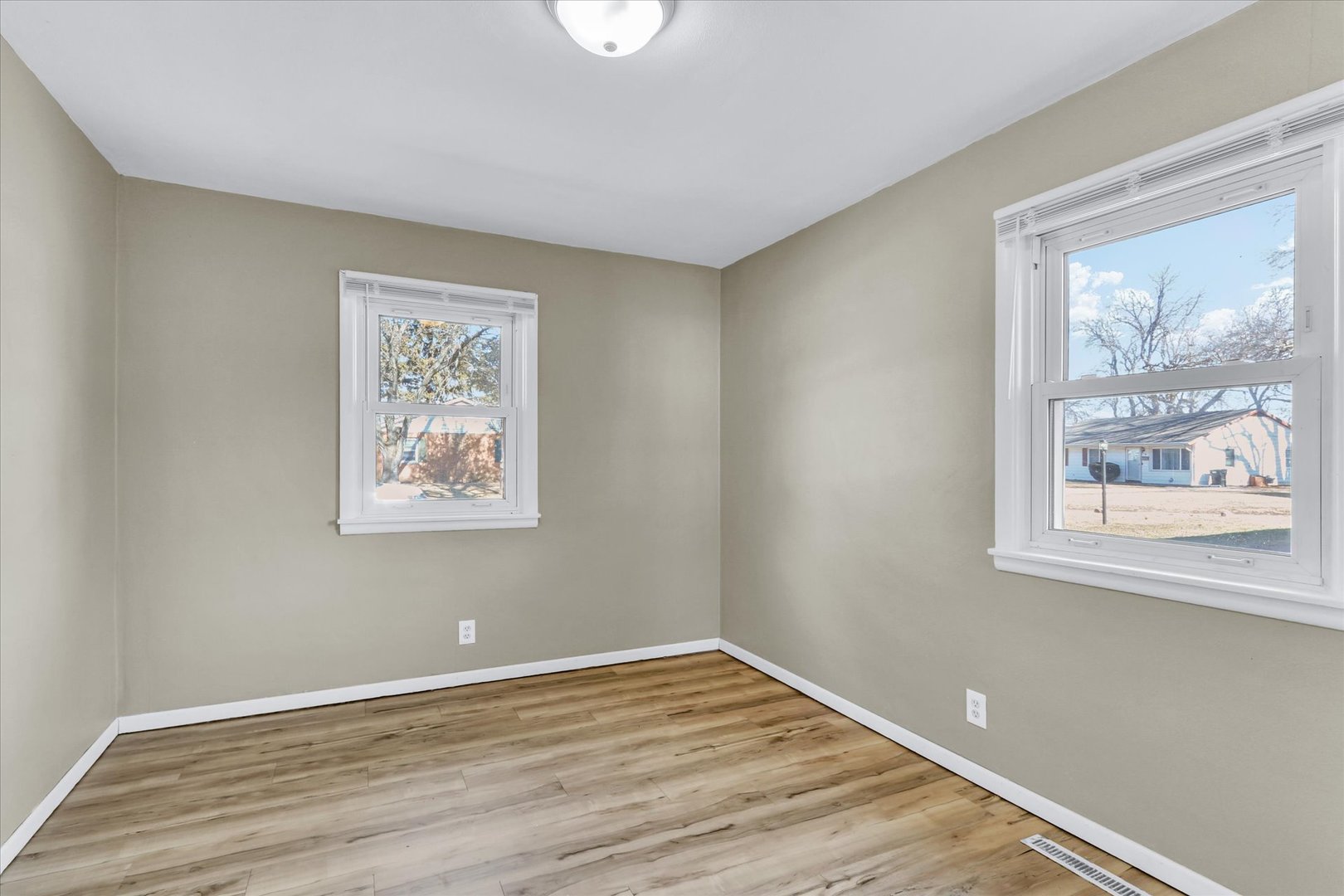 4 Hedge Court Champaign, IL 61821 - Photo 17 of 23 a view of an empty room with wooden floor and a window