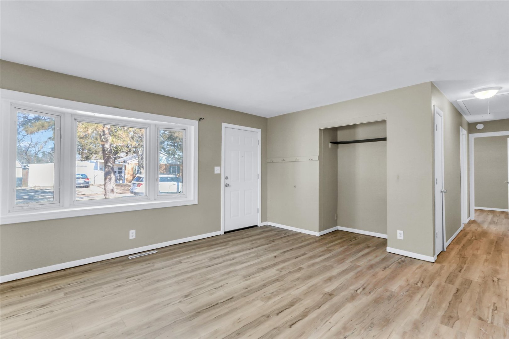 4 Hedge Court Champaign, IL 61821 - Photo 5 of 23 an empty room with wooden floor and windows