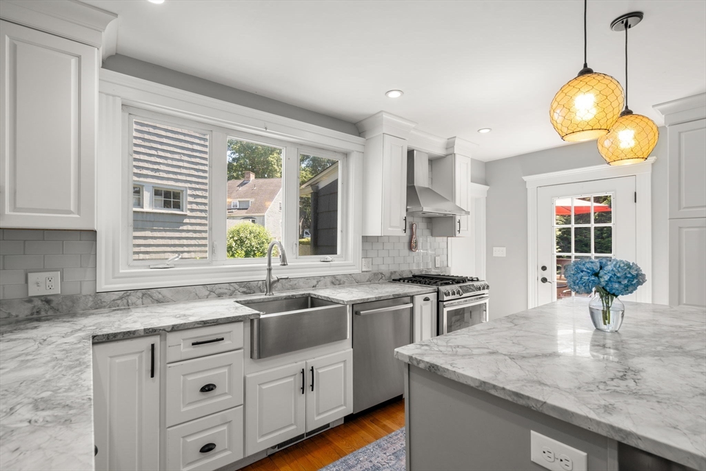 27 Frothingham Street Milton, MA 02186 - Photo 12 of 32 a kitchen with a sink stove and cabinets