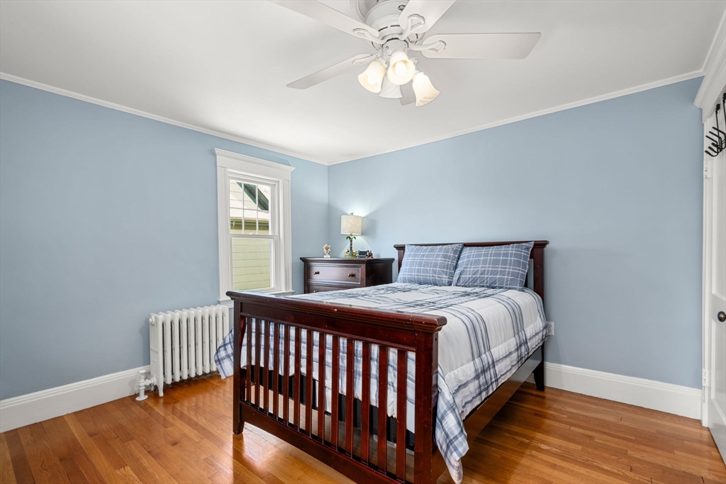 27 Frothingham Street Milton, MA 02186 - Photo 18 of 32 a bedroom with a bed and a chandelier
