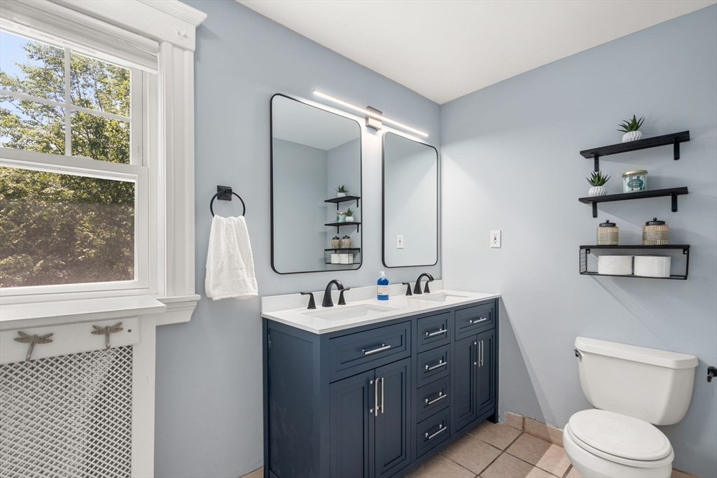 27 Frothingham Street Milton, MA 02186 - Photo 20 of 32 a bathroom with a double vanity sink toilet and a mirror