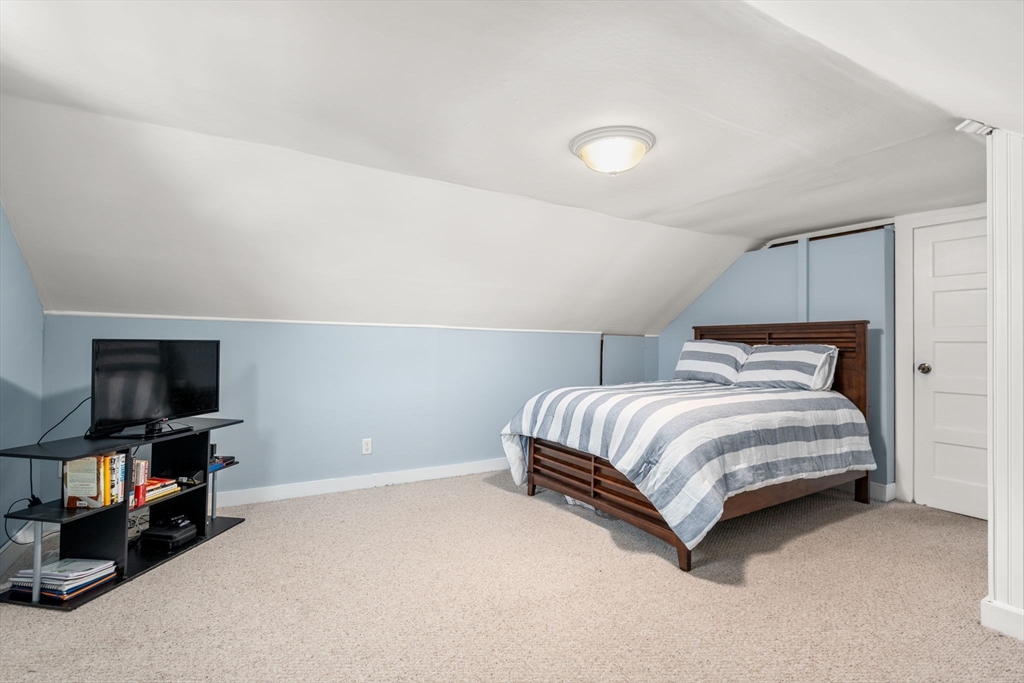 27 Frothingham Street Milton, MA 02186 - Photo 21 of 32 a bedroom with a bed and a flat screen tv