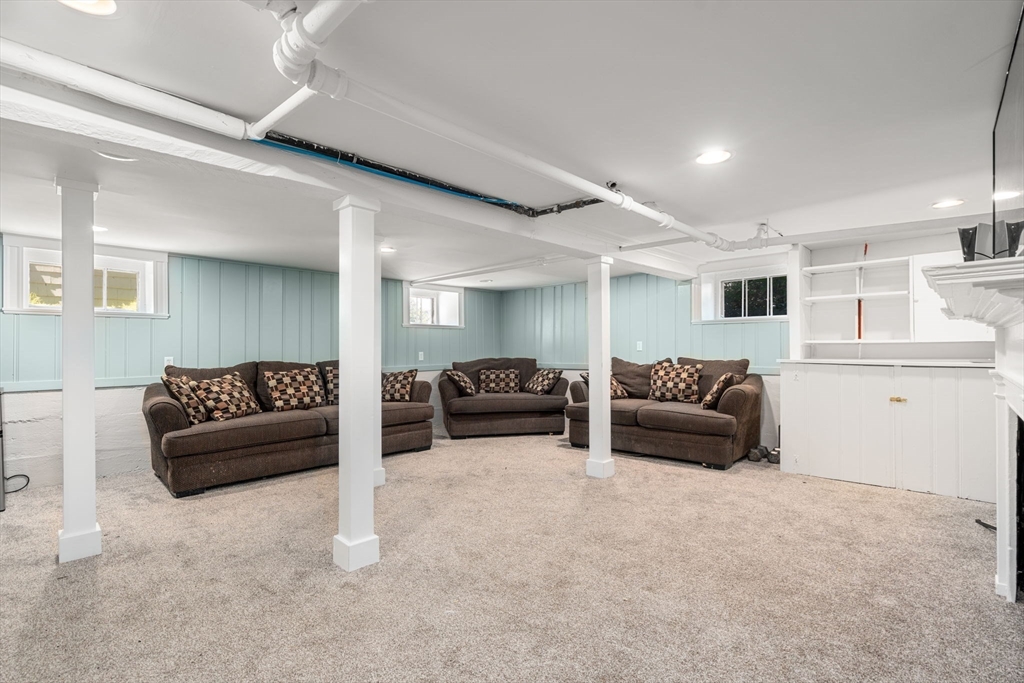 27 Frothingham Street Milton, MA 02186 - Photo 24 of 32 a living room with furniture and a lamp