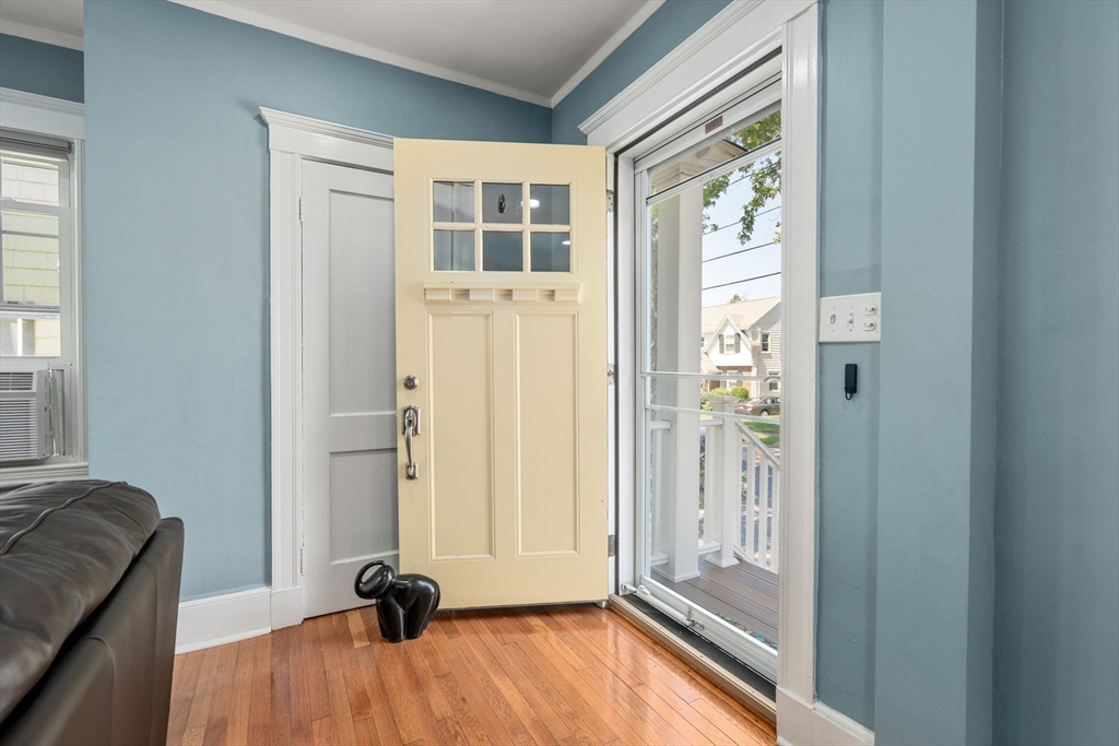 27 Frothingham Street Milton, MA 02186 - Photo 3 of 32 a view of a livingroom with wooden floor and a window