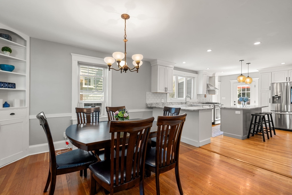 27 Frothingham Street Milton, MA 02186 - Photo 8 of 32 a view of a dining room and livingroom with furniture wooden floor a chandelier