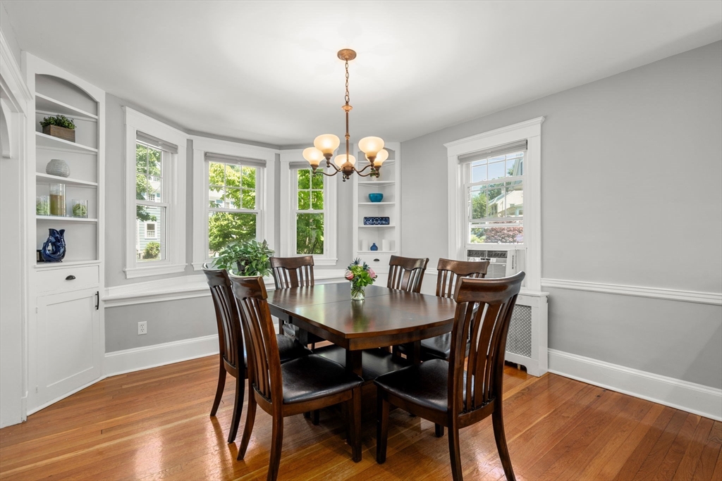 27 Frothingham Street Milton, MA 02186 - Photo 9 of 32 a dining room with furniture a chandelier and wooden floor