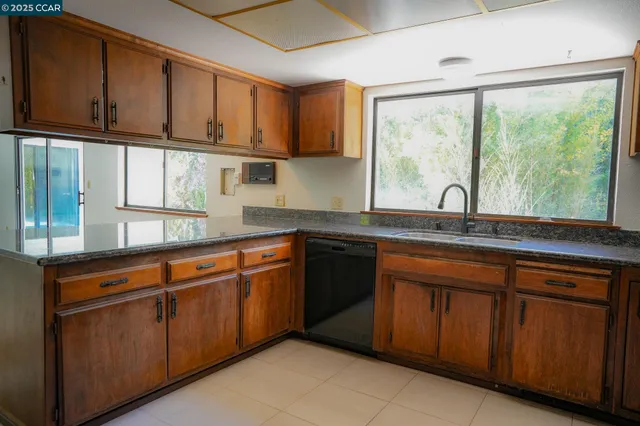 a kitchen with stainless steel appliances granite countertop a sink and cabinets