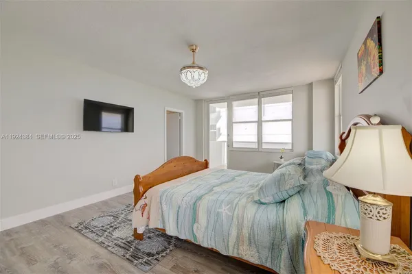 a bedroom with a bed a window and dresser