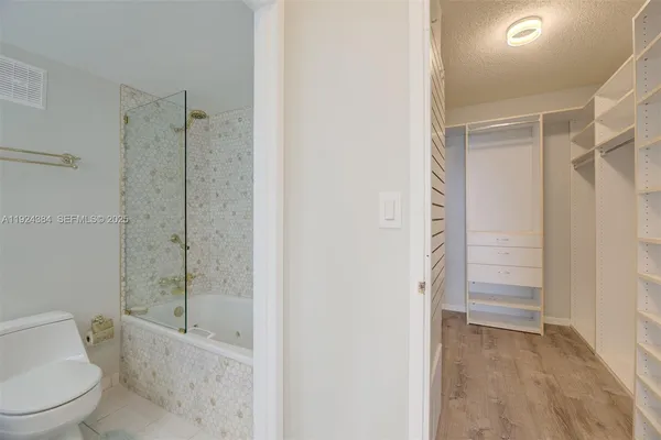 a bathroom with a shower a toilet and a sink